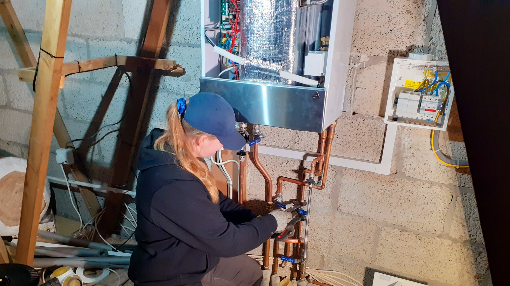 Taneisha De Gruchy installing a boiler