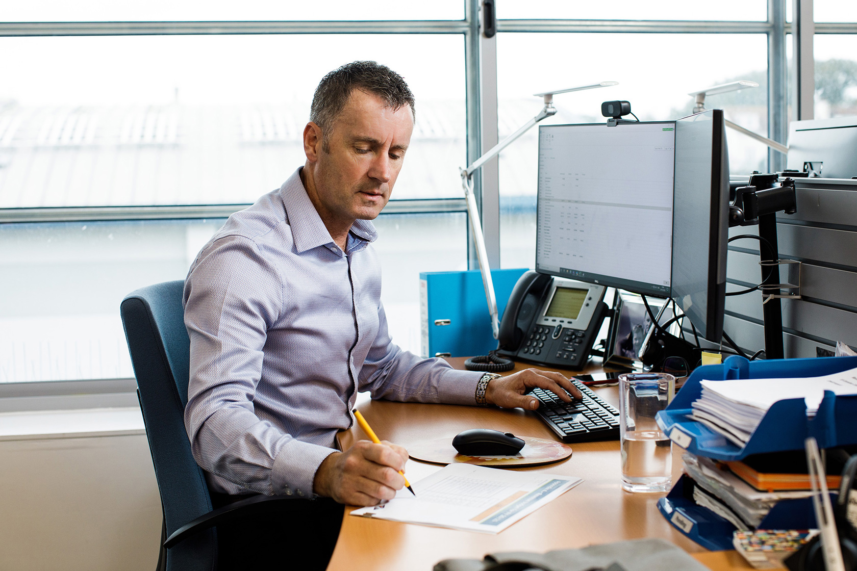 Andy Kemp works at his desk at the Jersey Electricy offices.