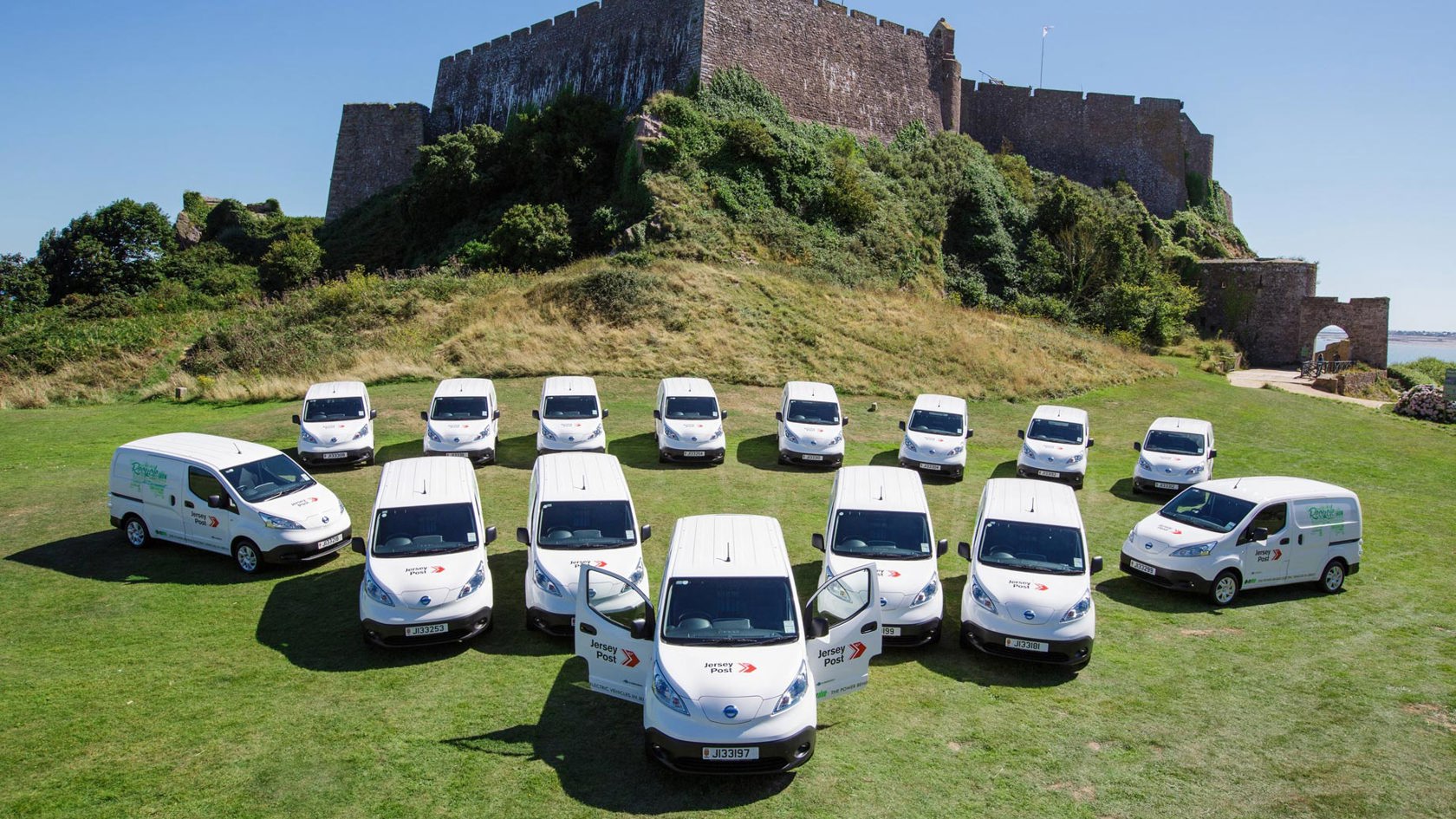 Jersey Post electric vans outside Gorey castle