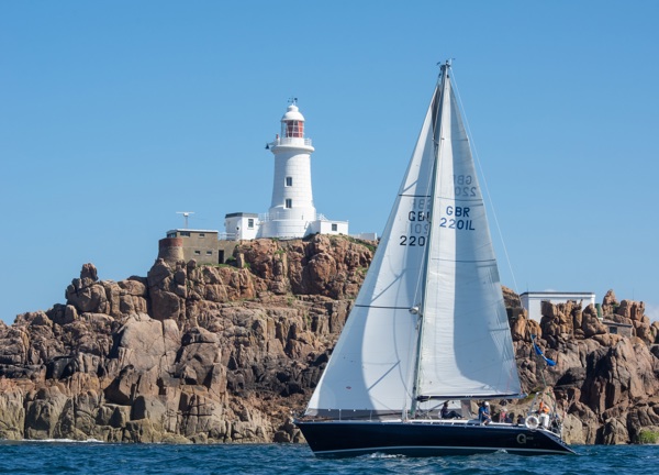 Sailing boat passes Corbiere lighthouse