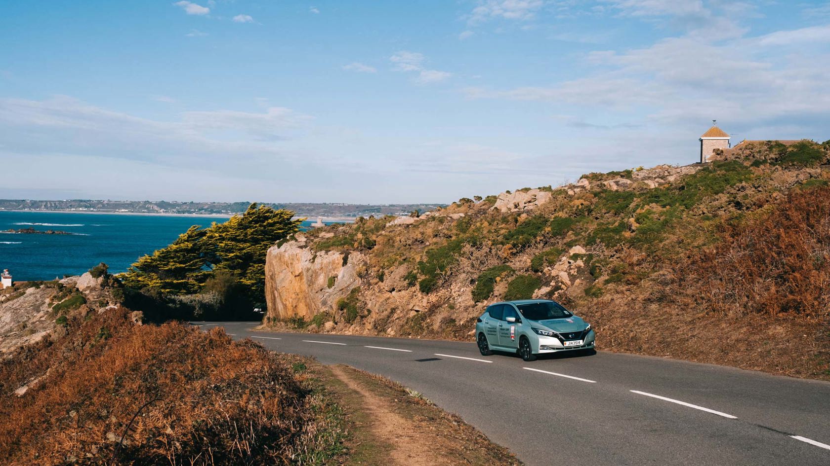 Electric car drives up a hill