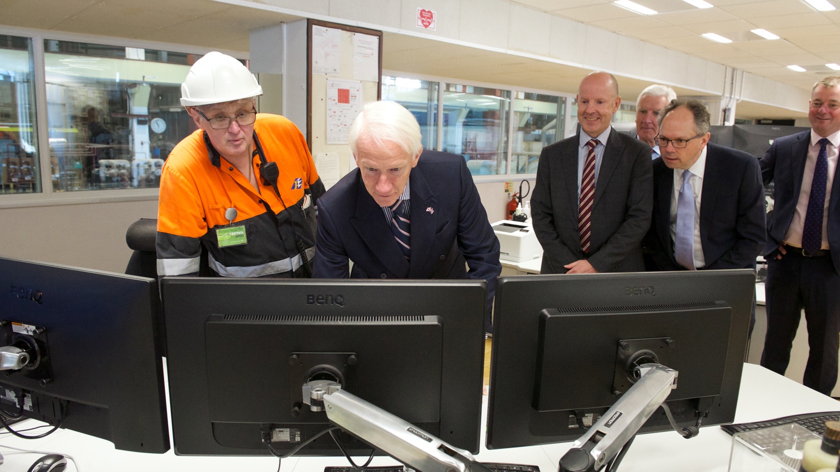 Engineer shows Lieutenant Governor computer systems at La Collette power station