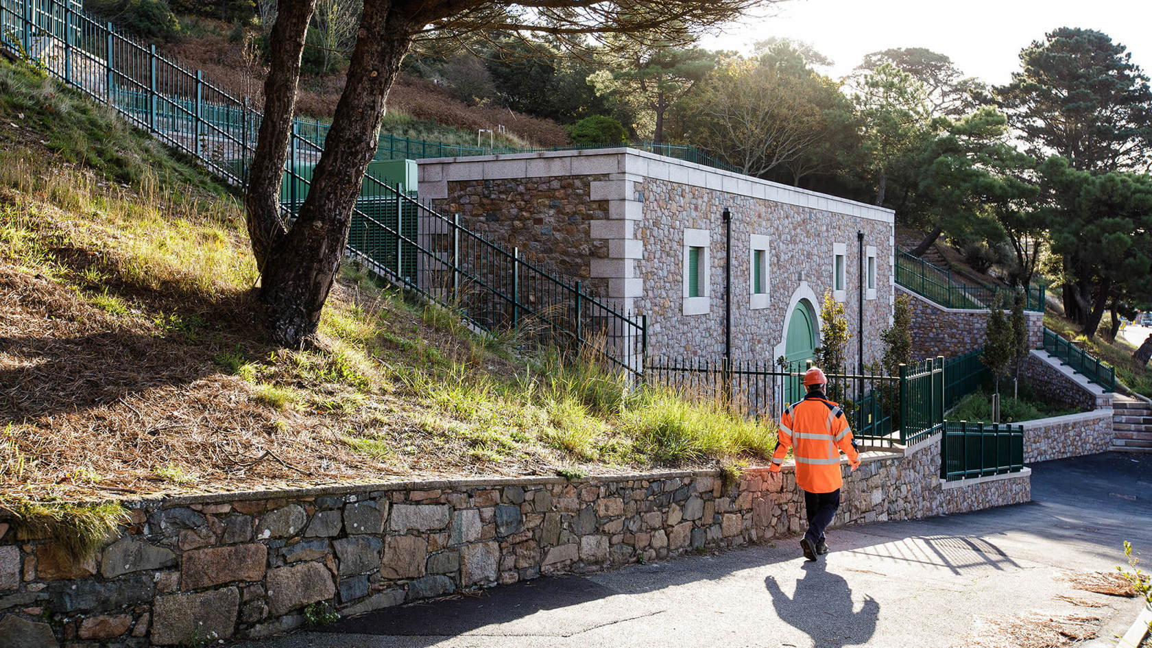 A Jersey Electricity worker walks past the St Helier West substation.