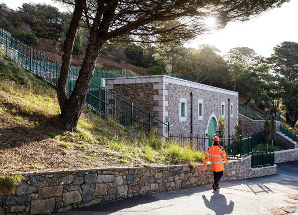 A Jersey Electricity worker walks past the St Helier West substation.