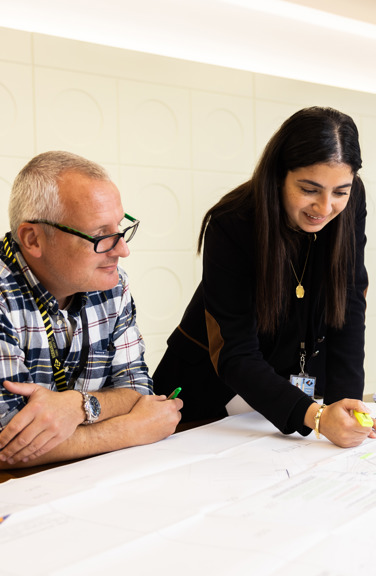 Peter and Elissar look over drawings at Jersey Electricity's head office