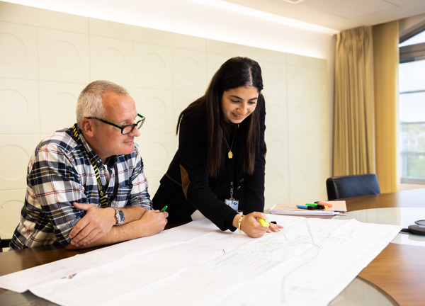 Peter and Elissar look over drawings at Jersey Electricity's head office