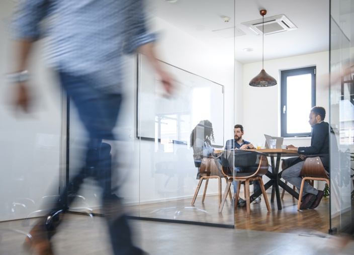 Four people in a meeting in a modern office