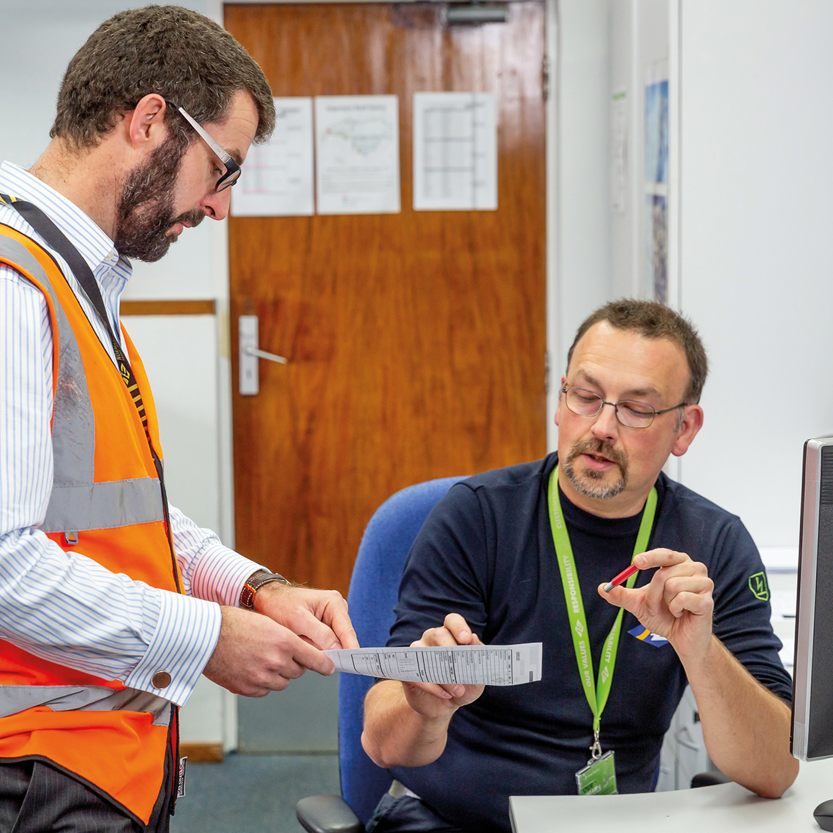 Richard Marriot discusses a document with a colleague.