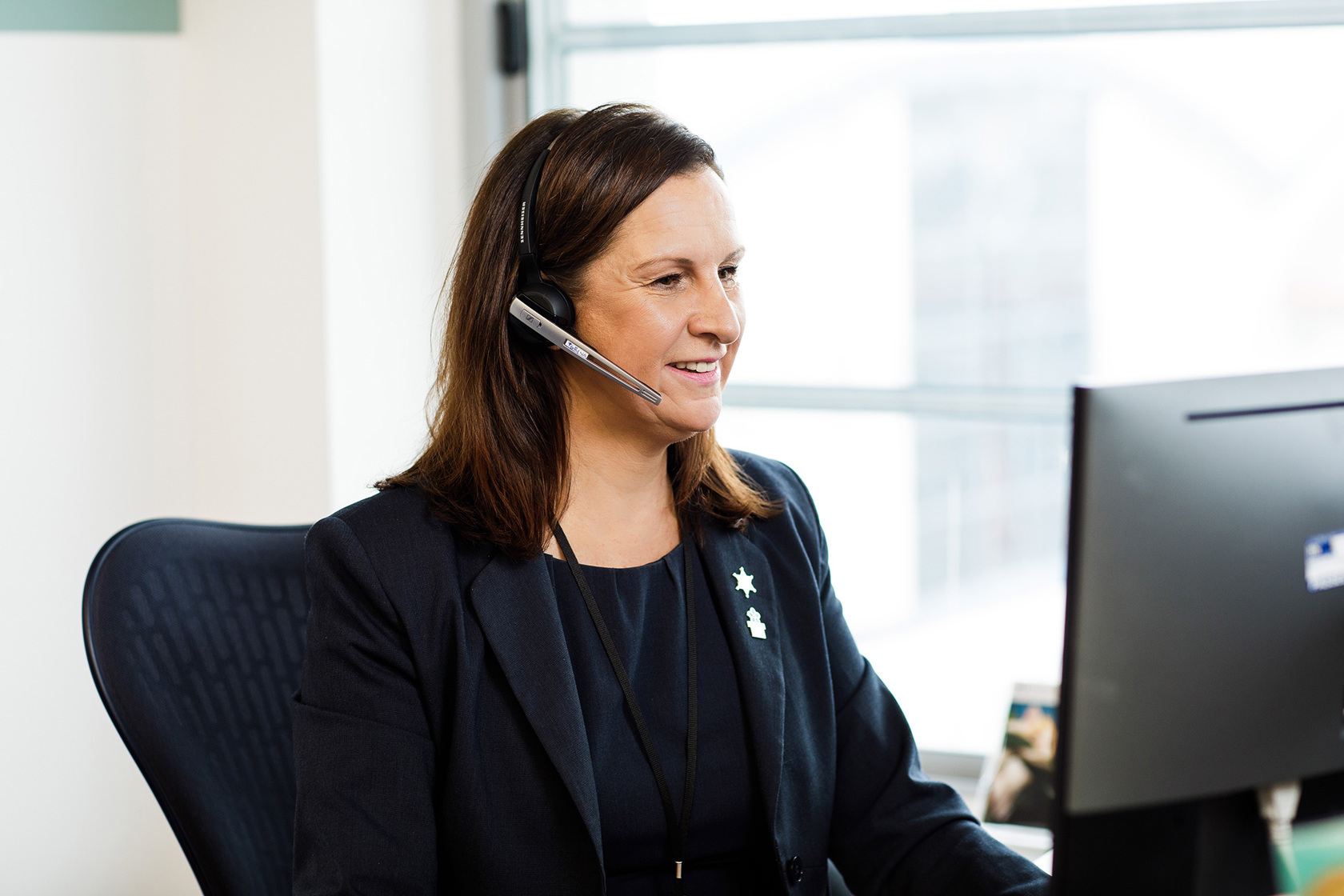 A member of Jersey Electricity's Customer Care team helps a customer.