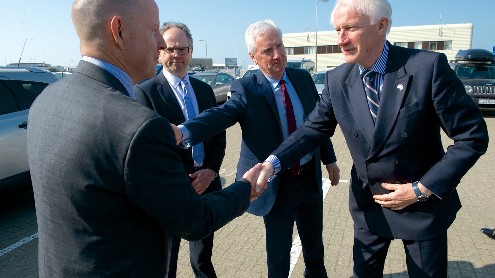 Four men shaking hands