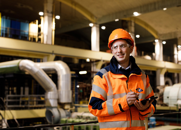 A Jersey Electricity employee takes notes on a tablet