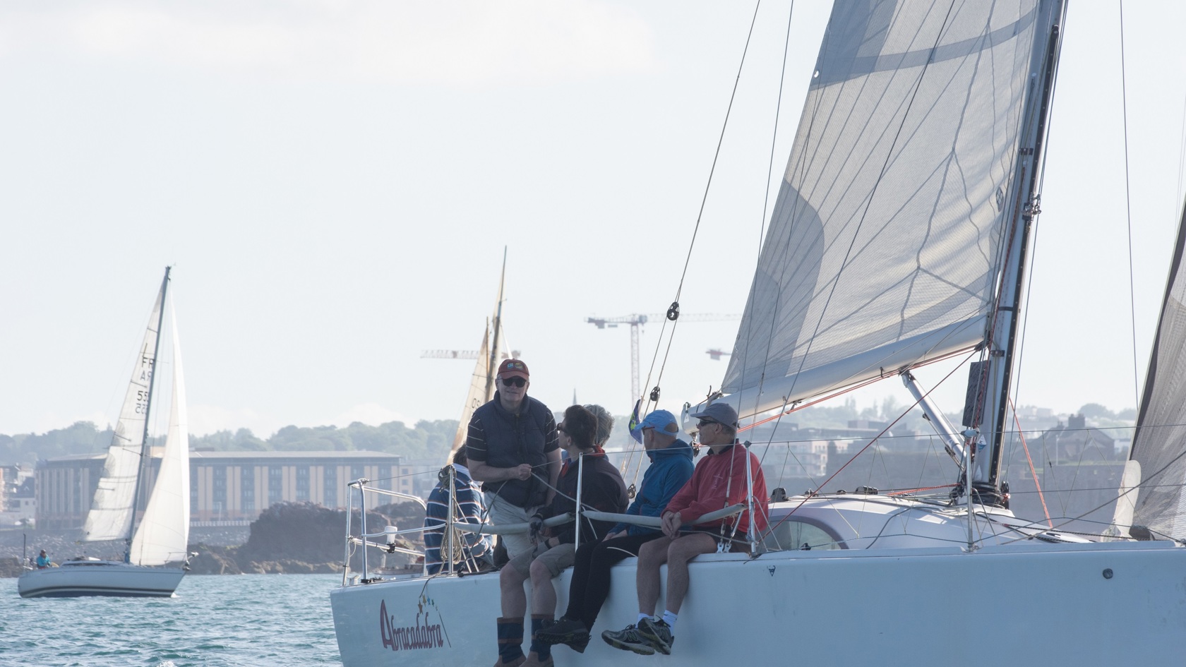 Yacht crew sat on the rail