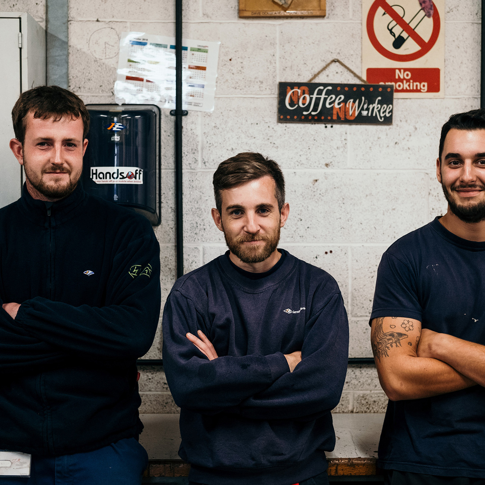 Three Jersey Electricity apprentices in the workshop.