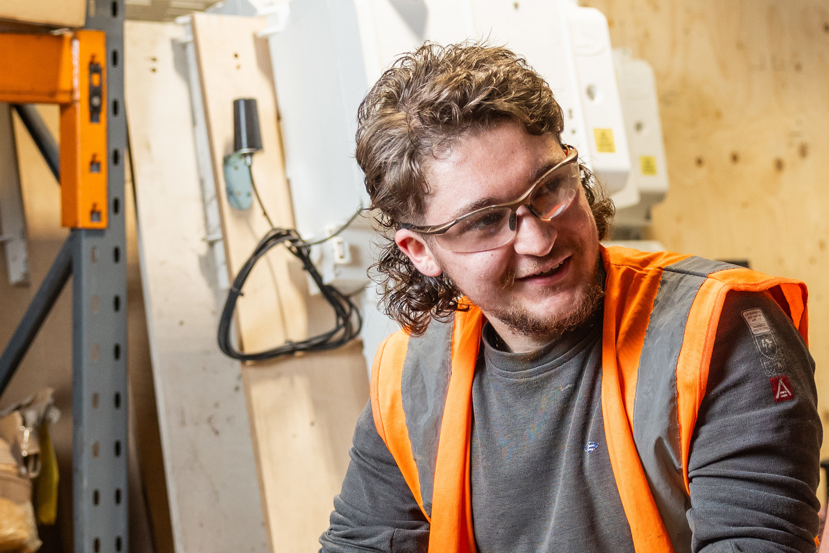 Image of Cody O'Gorman in a workshop wearing safety goggles and a high vis jacket