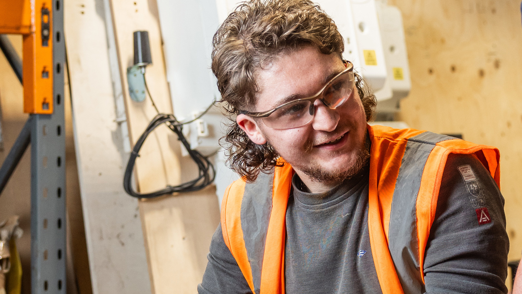 Image of Cody O'Gorman in a workshop wearing safety goggles and a high vis jacket