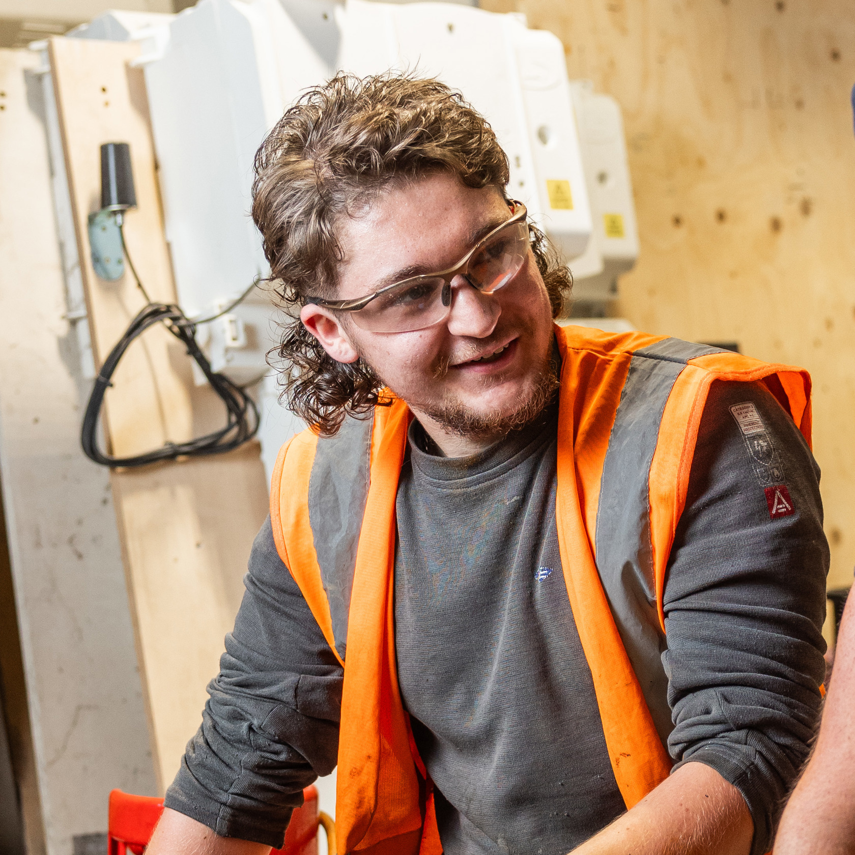 Image of Cody O'Gorman in a workshop wearing safety goggles and a high vis jacket