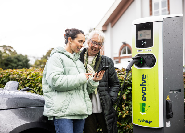 Evolve charge point with two ladies standing by to start their charge