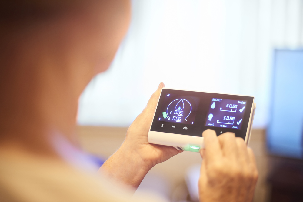 A woman tracks her electricity usage on a device which connects to her smart meter.