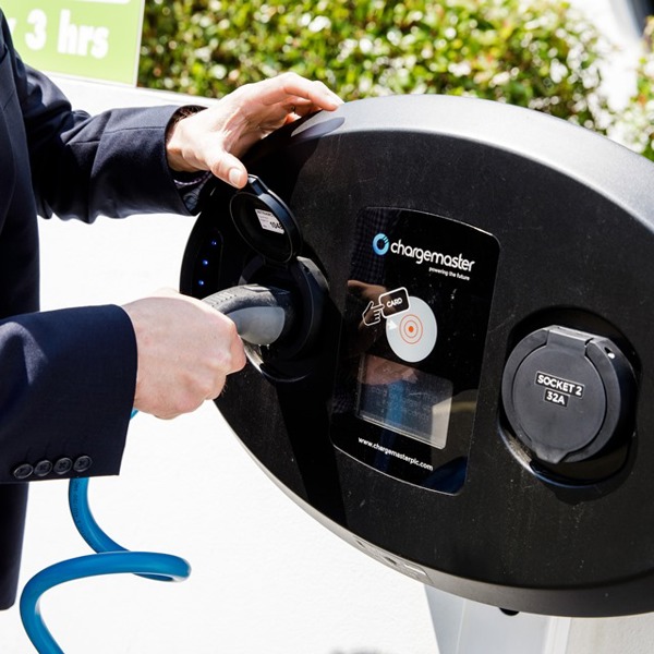 Man operates an electric vehicle charger
