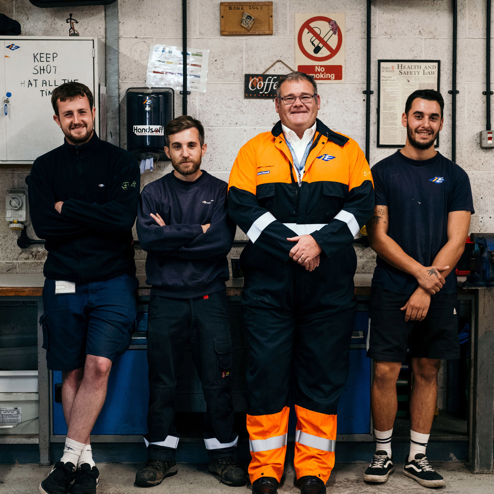 Four Jersey Electricity employees in the workshop.