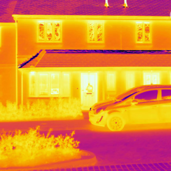 Thermal image of the outside of a house and a car parked at the front