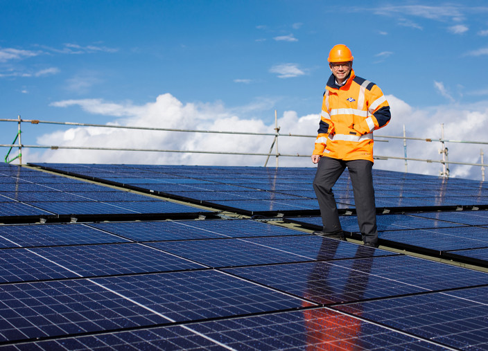 Chris Ambler, Jersey Electricity's CEO, stands on the roof at Jersey Dairy.