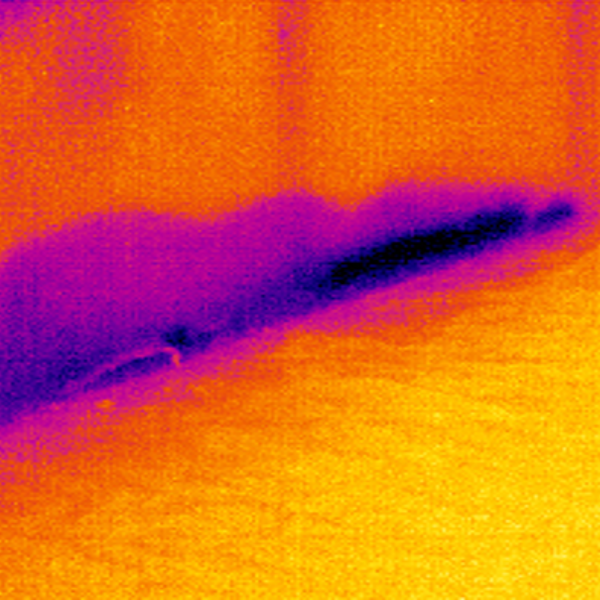 Thermal image showing water damage at the base of an internal wall