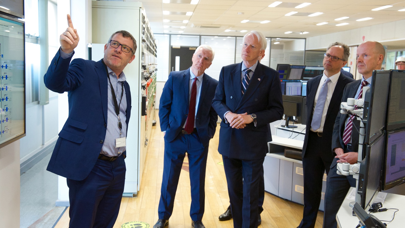 Jersey Electricity staff shows Lieutenant Governor computer systems at La Collette power station