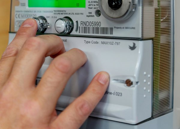 A Jersey Electricity customer operates their smart meter.