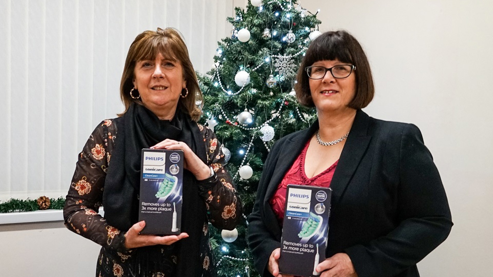 Family Nursing team members in front of Christmas tree