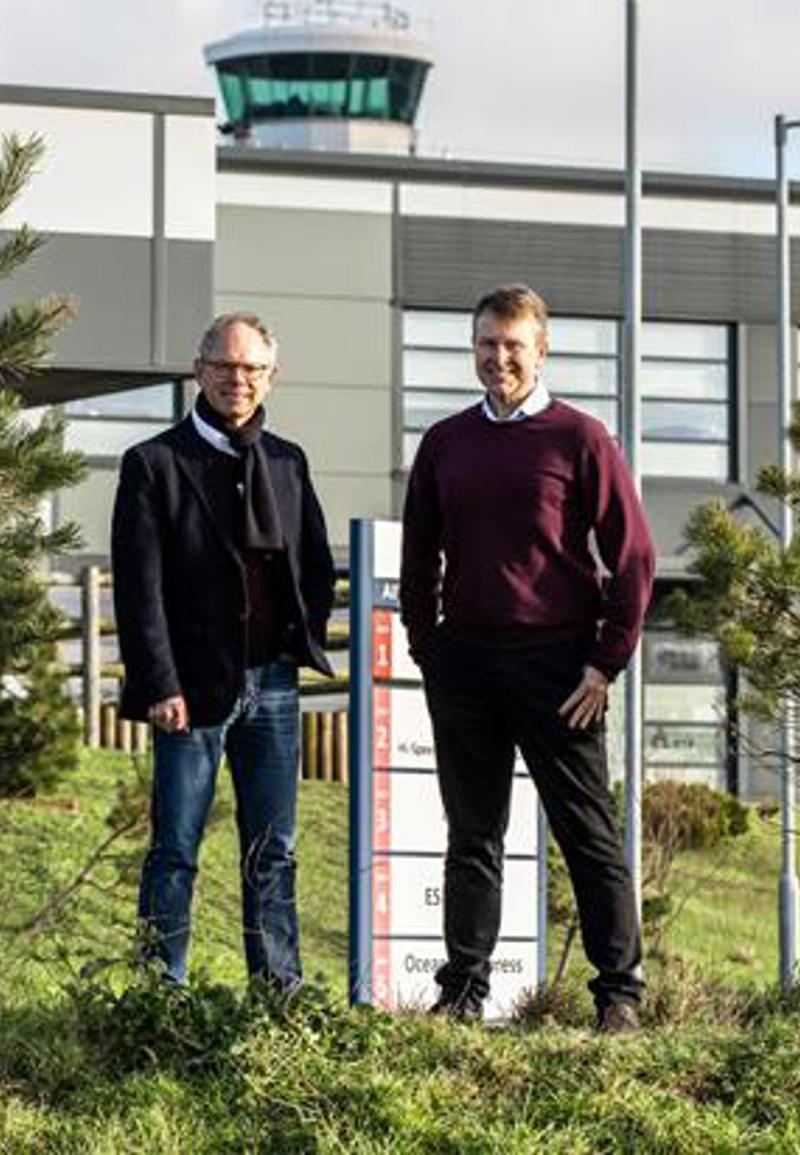 Chris Ambler, CEO at JE, and Matt Thomas, CEO at Ports of Jersey, stood amongst greenery outside of Jersey Airport
