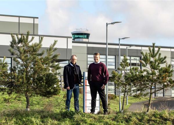 Chris Ambler, CEO at JE, and Matt Thomas, CEO at Ports of Jersey, stood amongst greenery outside of Jersey Airport