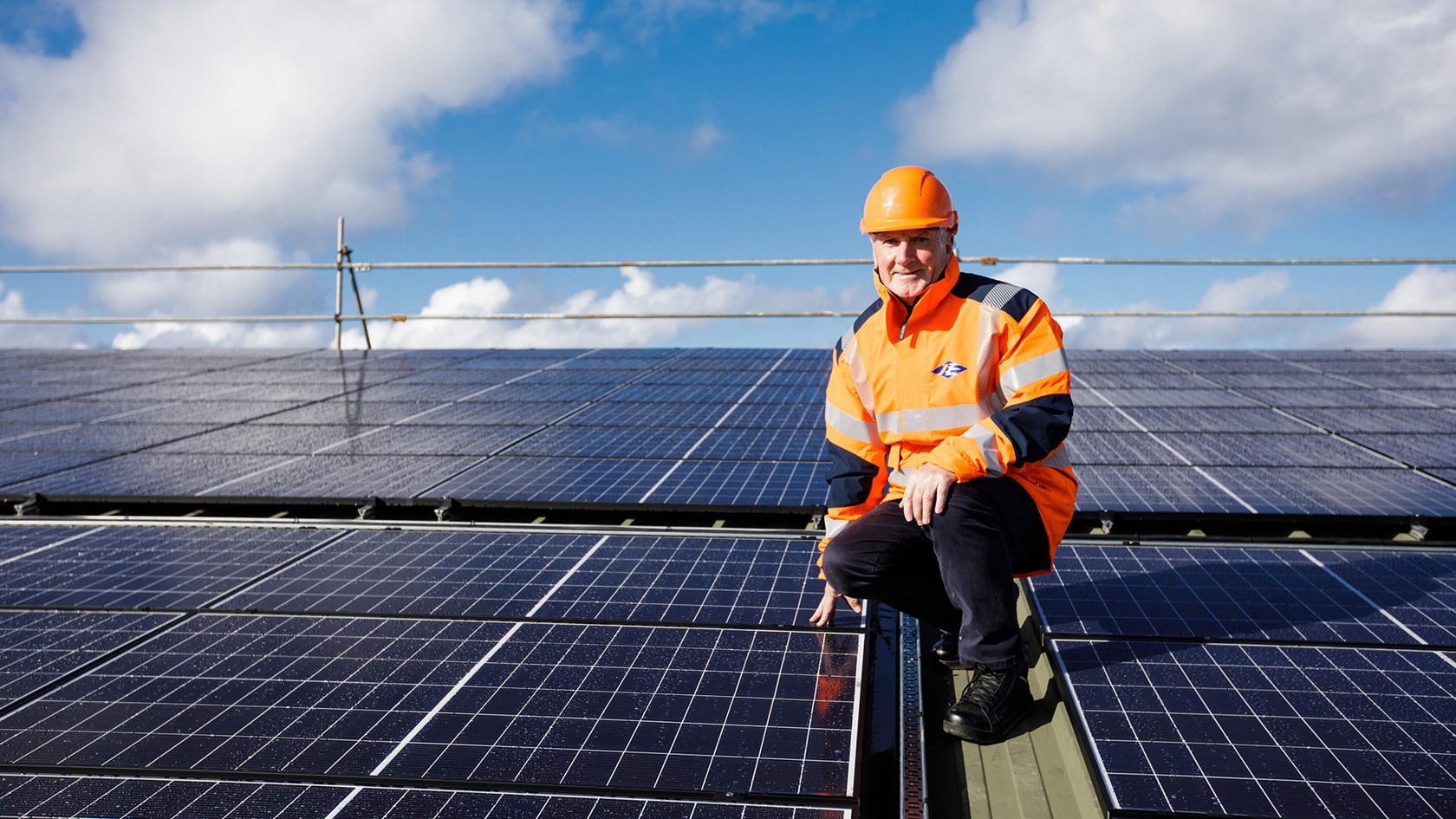 Phil Austin inspects the solar pv array on top the roof of Woodside Farm.