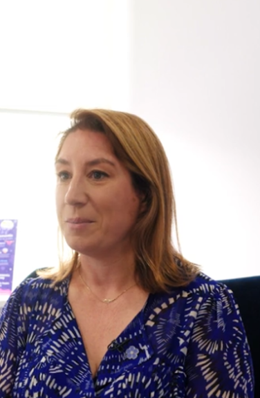 A person in a blue top sat on a chair