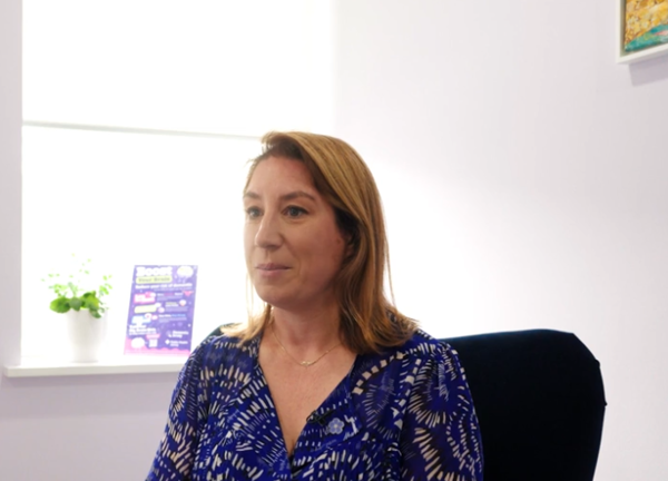 A person in a blue top sat on a chair