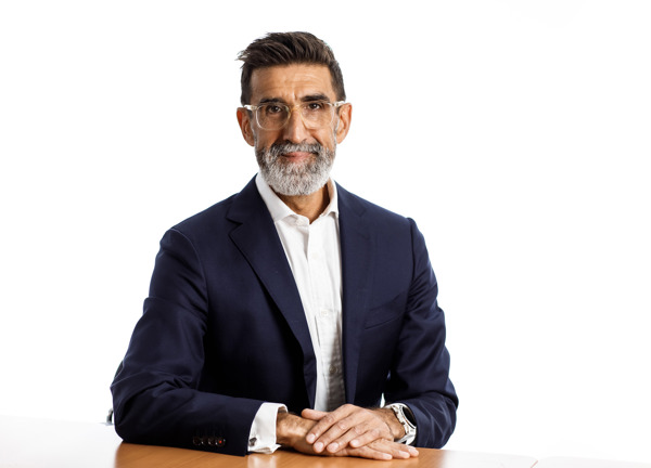 Andrew Welsby sitting at a table wearing a dark blazer and white shirt