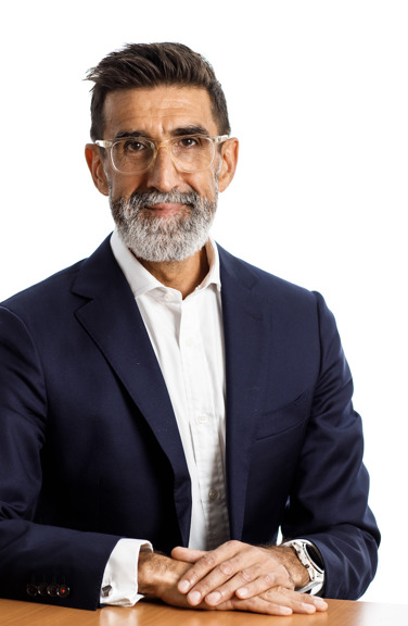 Andrew Welsby sitting at a table wearing a dark blazer and white shirt