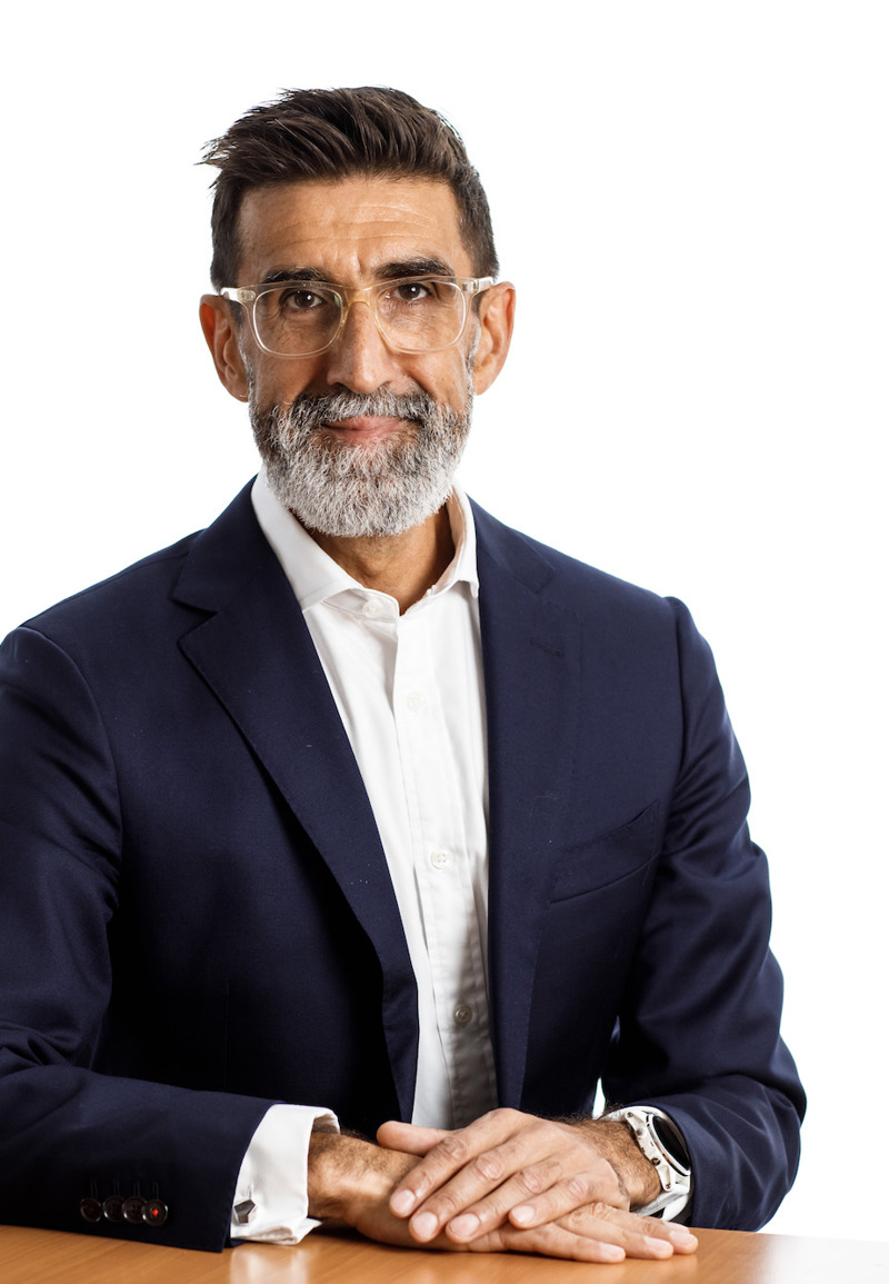 Andrew Welsby sitting at a table wearing a dark blazer and white shirt