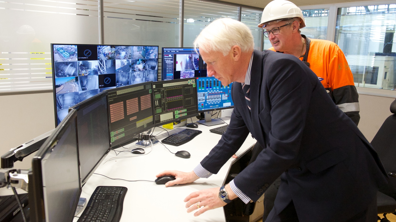 Engineer shows Lieutenant Governor computer systems at La Collette power station