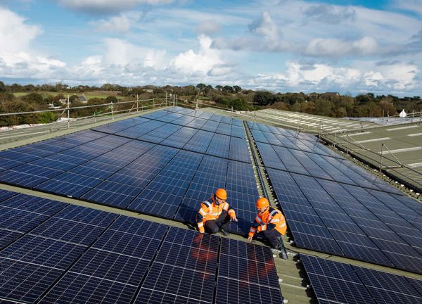 Two Jersey Electrcity team members inspect the Solar PV array installation at Woodside Farm.