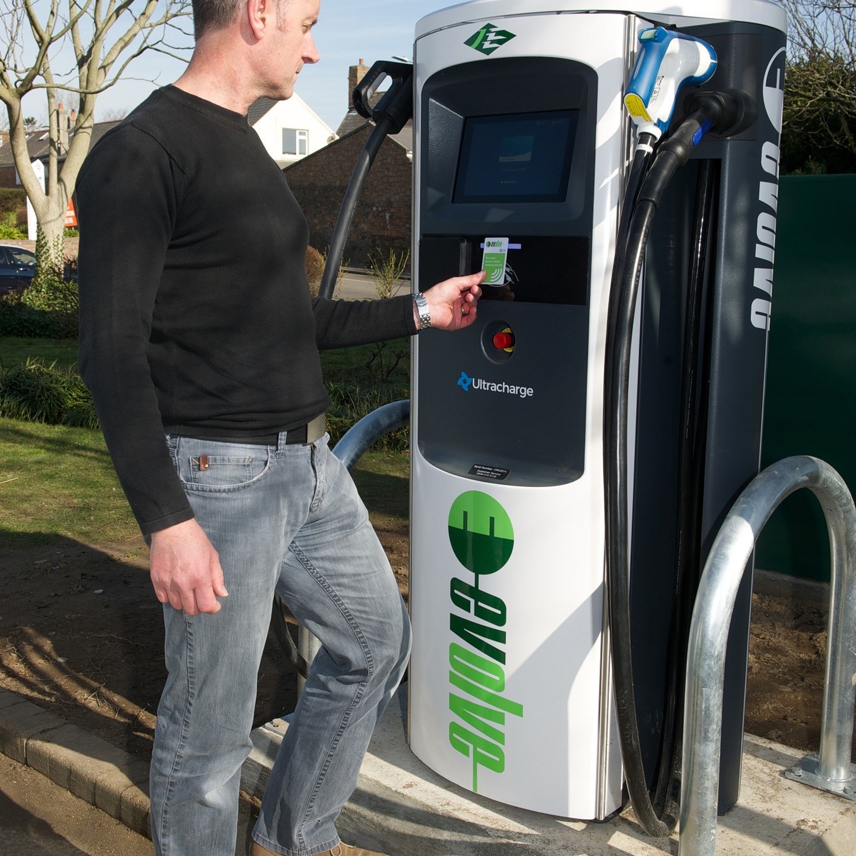 A man pays to use the electric cehicle charge at The Powerhouse.