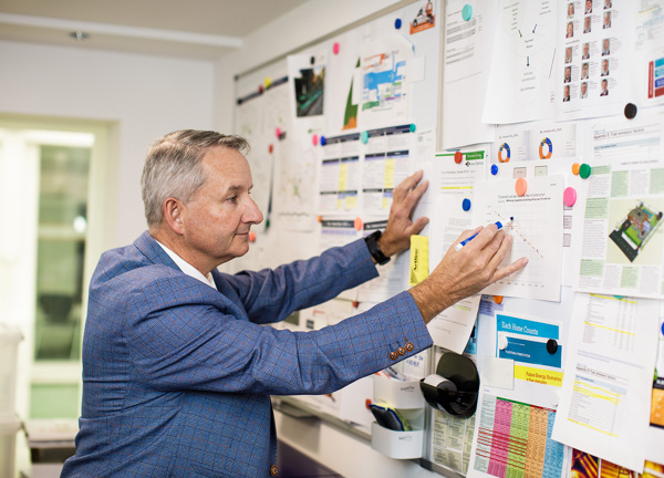 Peter Cadiou from the Energy Solutions team studies a graph in his office.