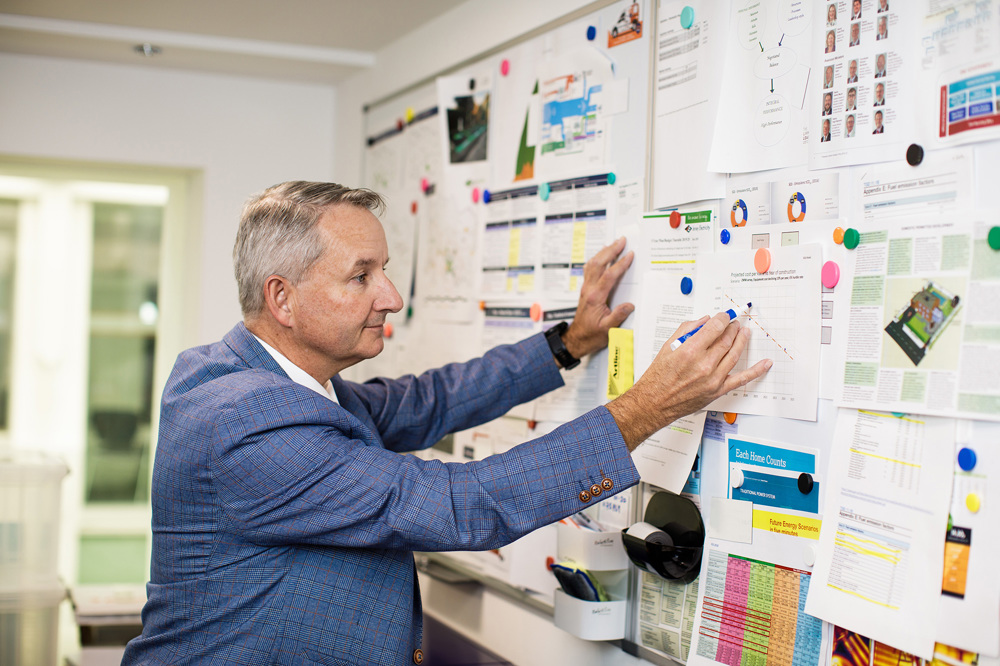 Peter Cadiou from the Energy Solutions team studies a graph in his office.