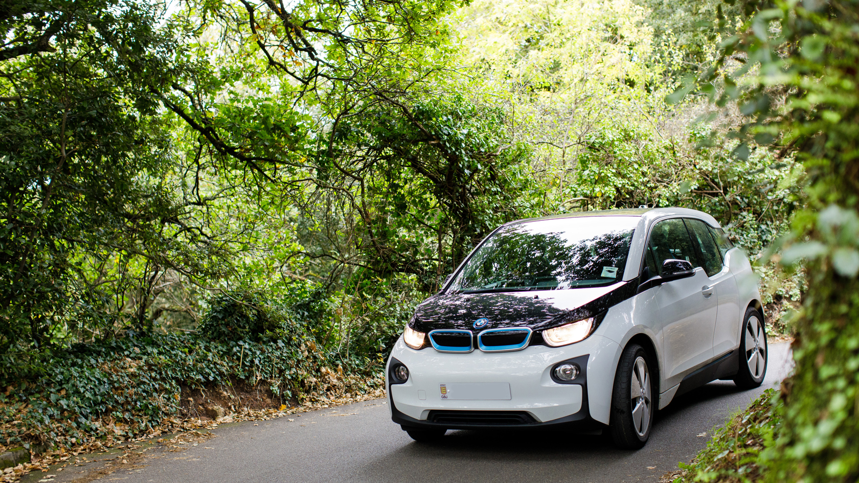 A BMW I3 driving in a country lane