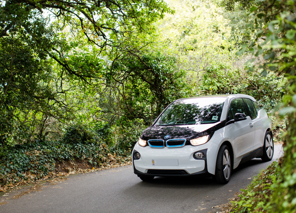 A BMW I3 driving in a country lane