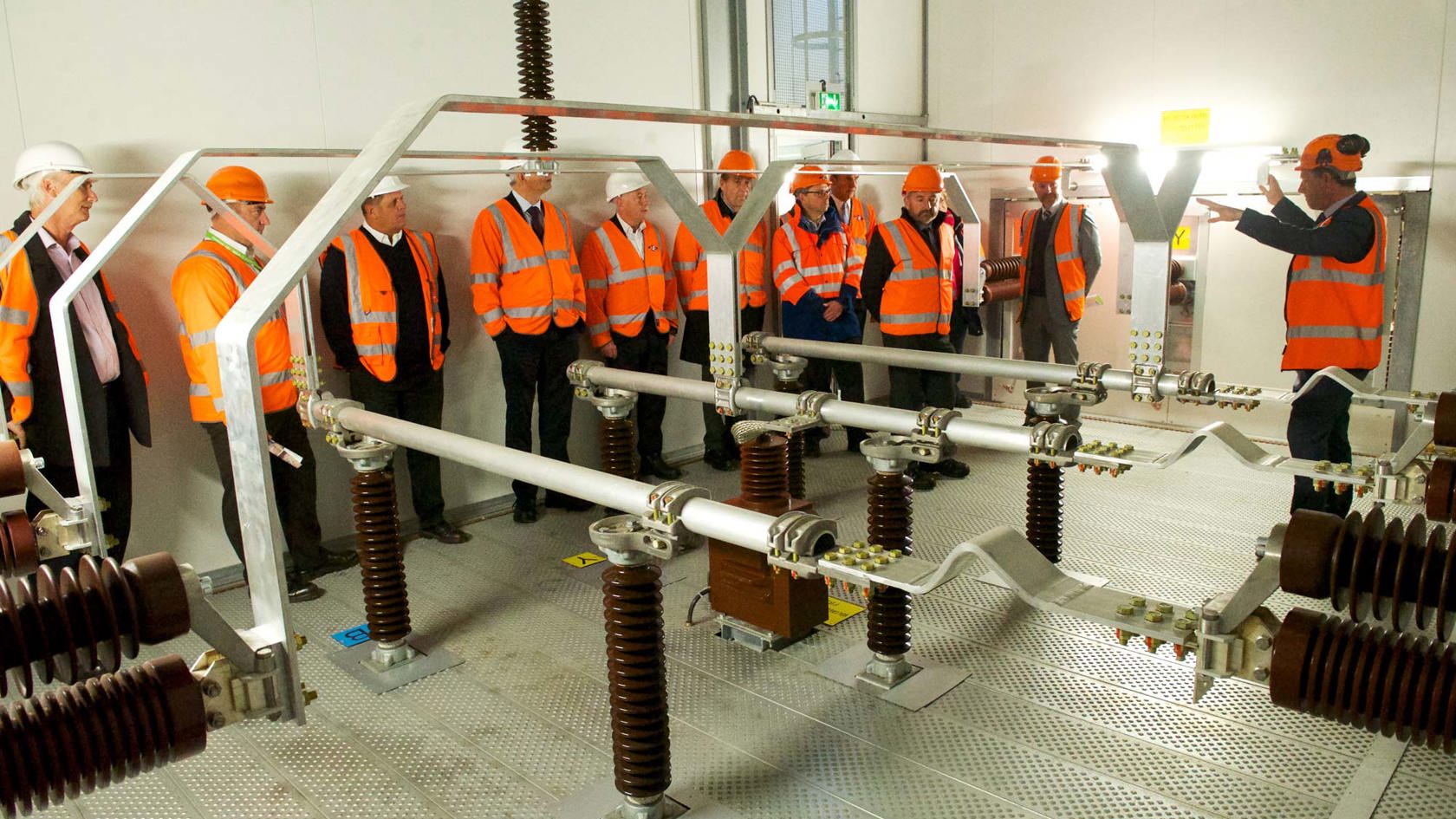 States members in hi vis vests get a tour of new substation