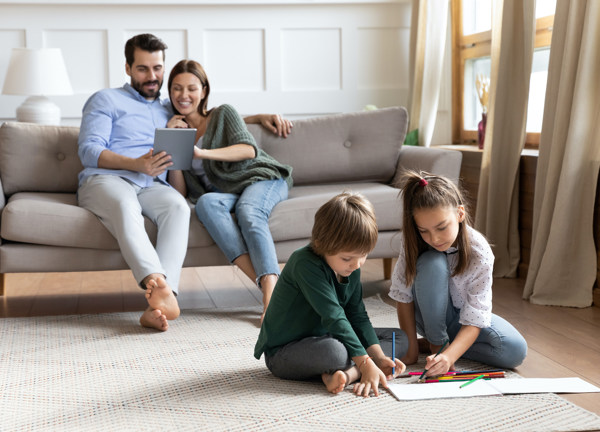 Family of four relaxing in comfy living room
