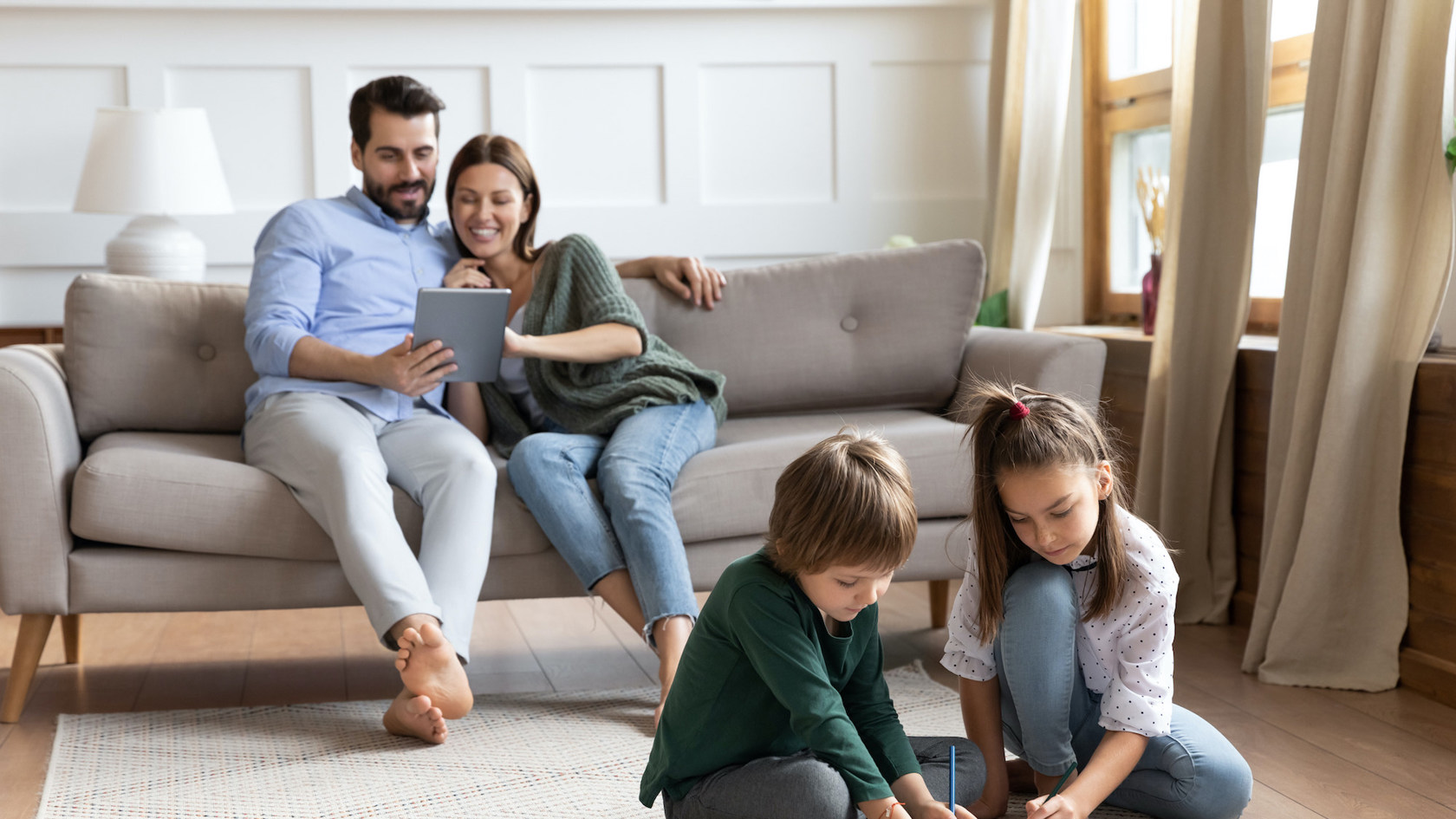 Family of four relaxing in comfy living room
