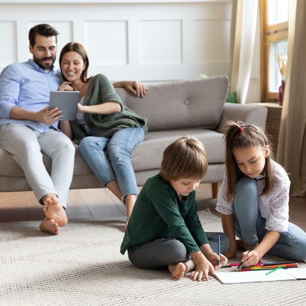 Family of four relaxing in comfy living room