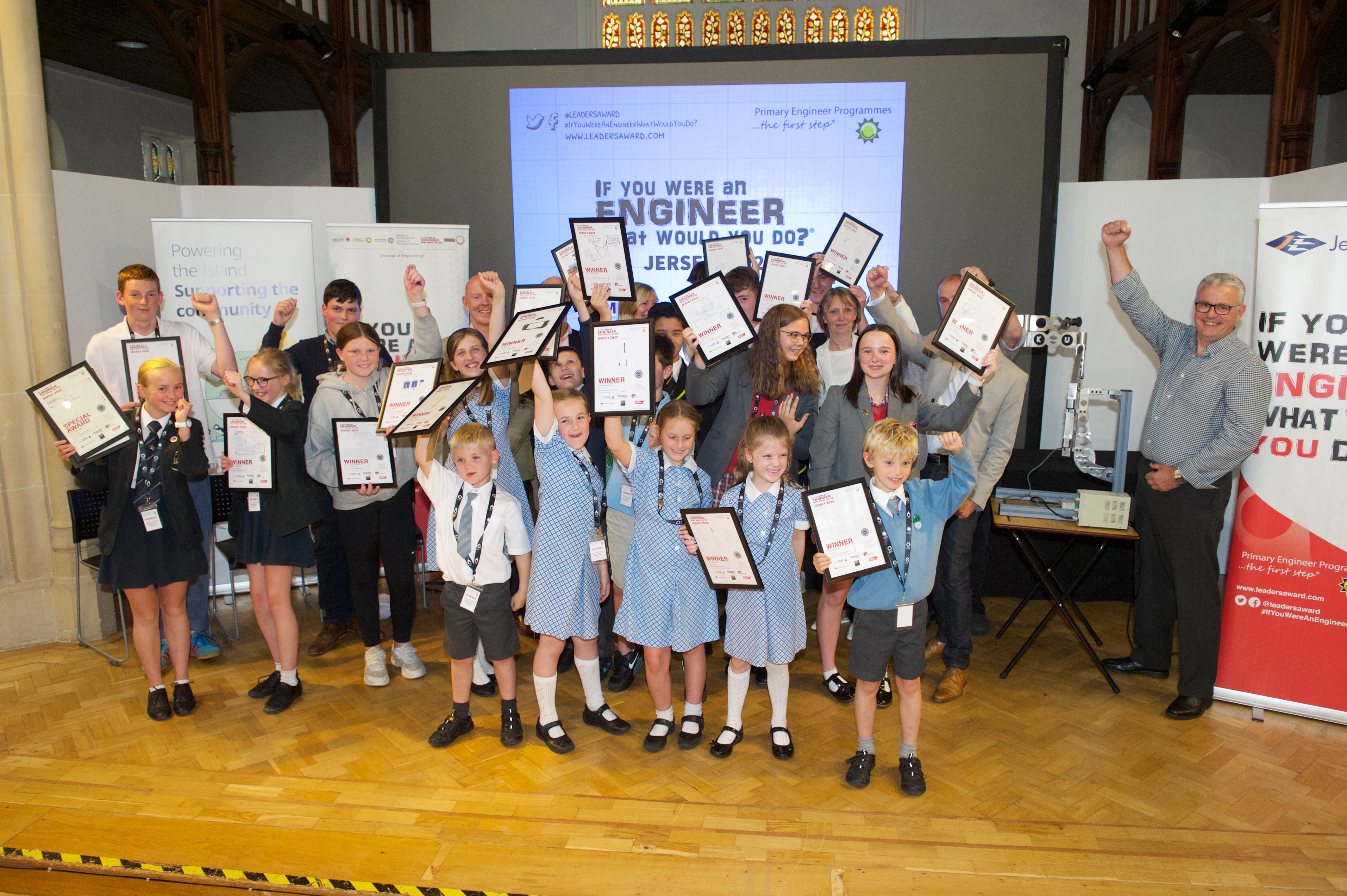 the winners of the Primary Engineer Awards holding their certificates above their heads and celebrating